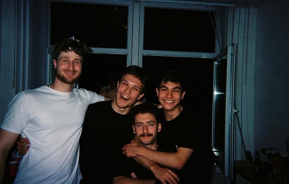 Friends crowded into a student room